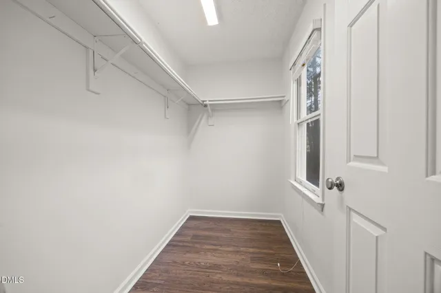 a view of a hallway with wooden floor and entryway