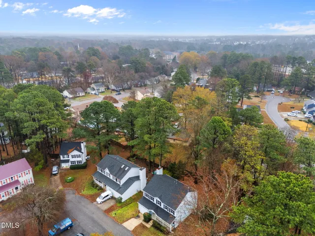 an aerial view of residential house with green space