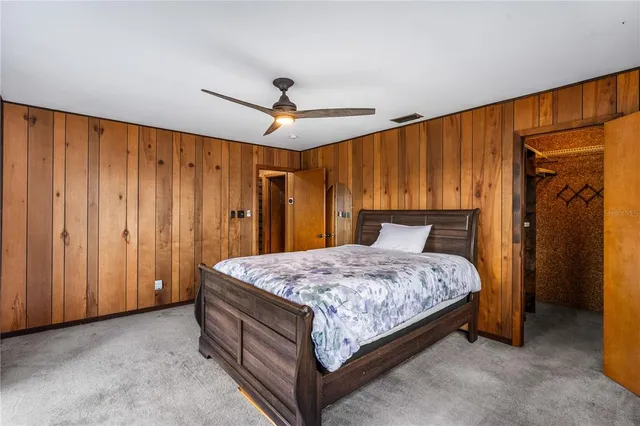 a spacious bedroom with a bed and a table