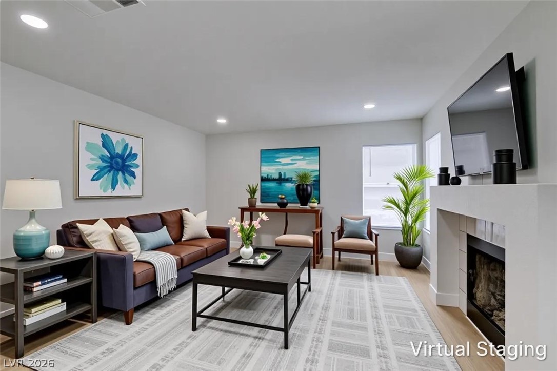 2113 Desert Peak Road Las Vegas, NV 89134 - Photo 11 of 33 Bright and inviting living space with a warm ambiance, ideal for gatherings.