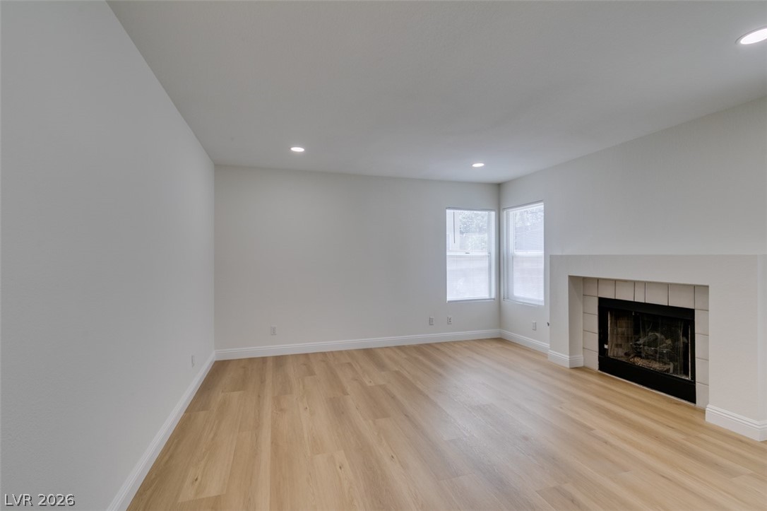 2113 Desert Peak Road Las Vegas, NV 89134 - Photo 12 of 33 Bright and airy living area with recessed lighting and warm wood flooring.