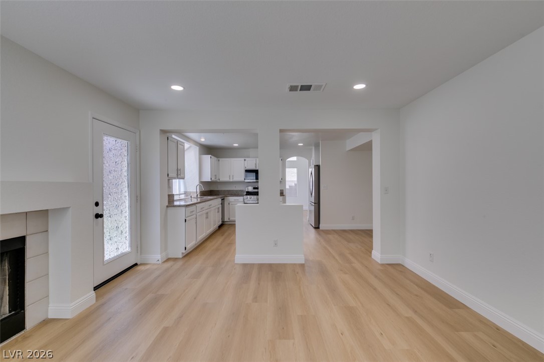 2113 Desert Peak Road Las Vegas, NV 89134 - Photo 33 of 33 This bright interior features an open floorplan with light wood flooring and recessed lighting throughout.