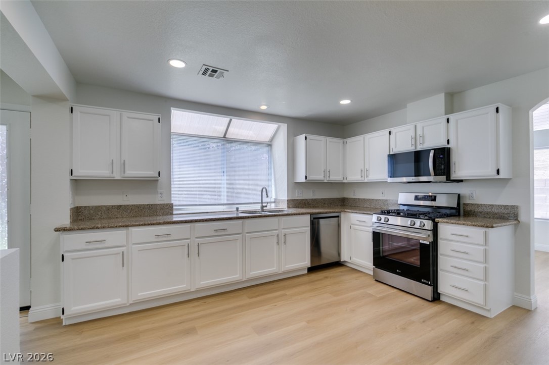2113 Desert Peak Road Las Vegas, NV 89134 - Photo 14 of 33 This bright kitchen features ample counter space and modern appliances for everyday living.