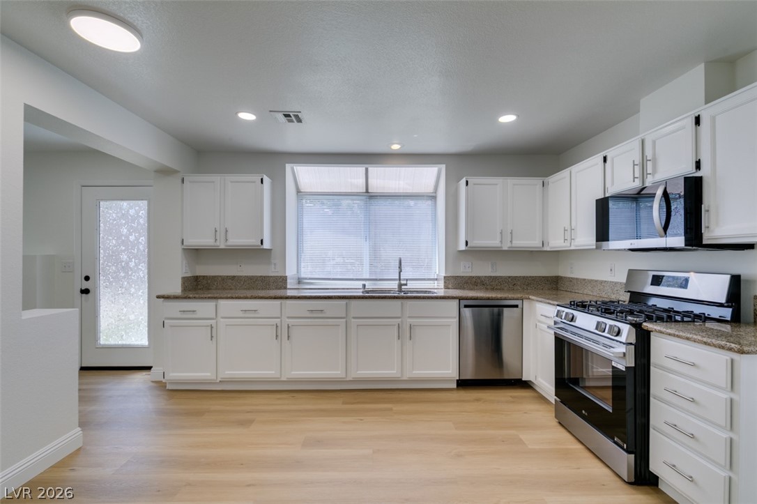 2113 Desert Peak Road Las Vegas, NV 89134 - Photo 18 of 33 This spacious kitchen offers ample cabinetry, modern appliances, and a bright, functional layout.