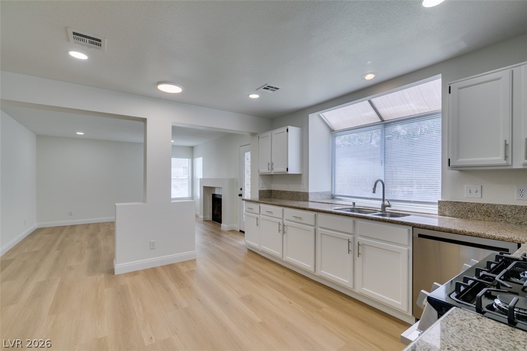 2113 Desert Peak Road Las Vegas, NV 89134 - Photo 19 of 33 This bright kitchen features wood flooring and a double basin sink, perfect for modern living.