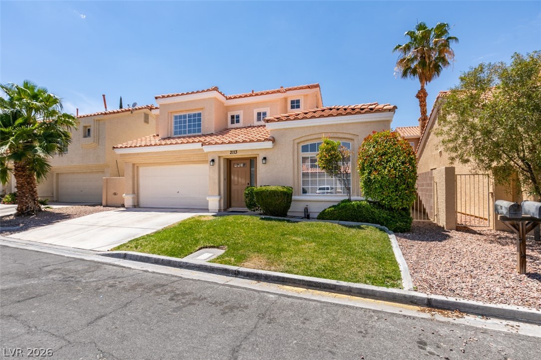 2113 Desert Peak Road Las Vegas, NV 89134 - Photo 2 of 33 This charming home offers a delightful facade with lush landscaping and a welcoming entrance.
