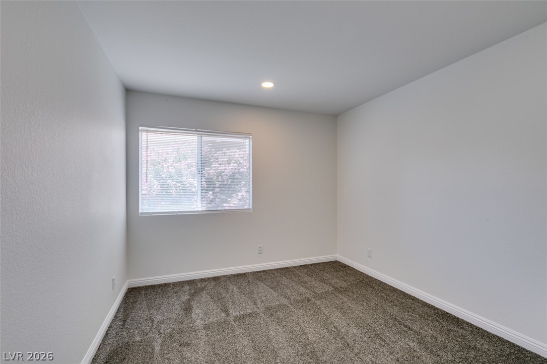 2113 Desert Peak Road Las Vegas, NV 89134 - Photo 22 of 33 This cozy room offers natural light and a soft carpeted floor, ready for your personal touch.
