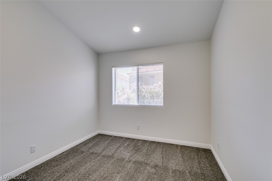 2113 Desert Peak Road Las Vegas, NV 89134 - Photo 24 of 33 This cozy room offers natural light and a soft carpeted floor.