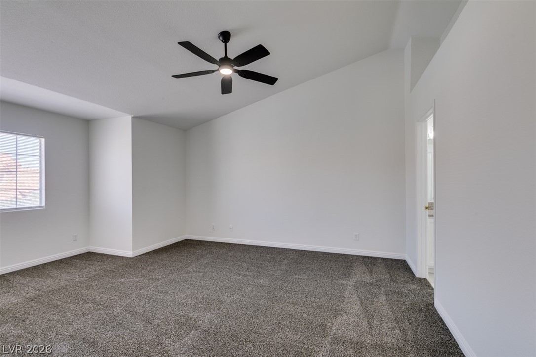 2113 Desert Peak Road Las Vegas, NV 89134 - Photo 27 of 33 This spacious bedroom offers high ceilings and plush carpeting, creating a comfortable and inviting atmosphere.
