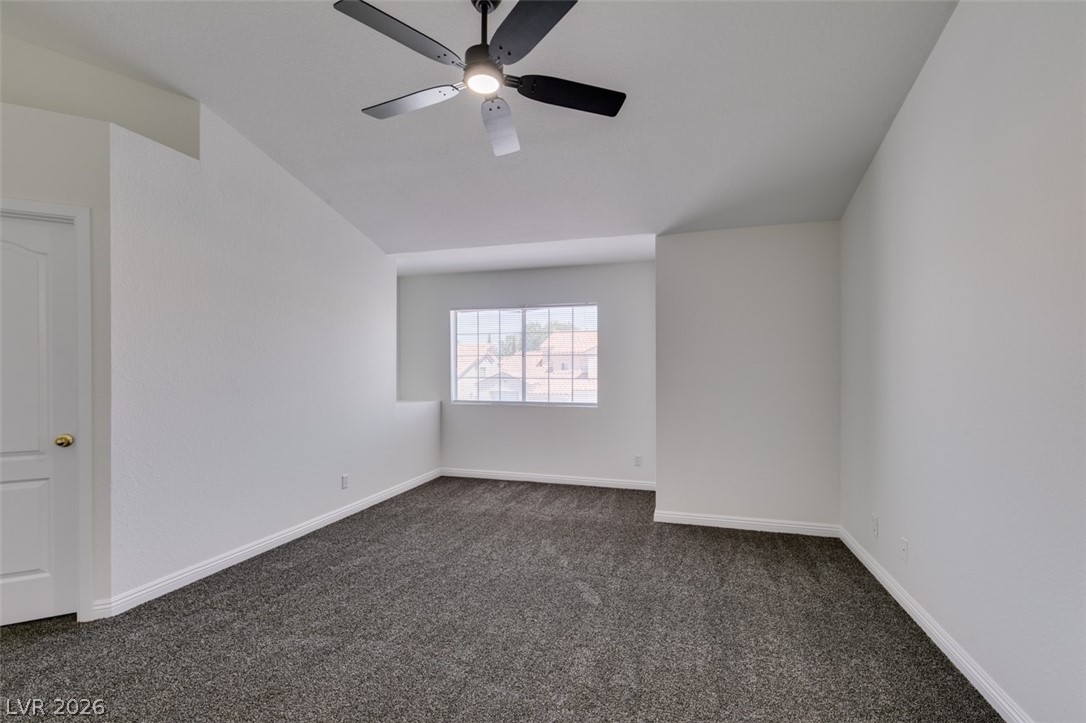 2113 Desert Peak Road Las Vegas, NV 89134 - Photo 28 of 33 This airy bedroom features plush carpeting and abundant natural light, creating a bright and inviting atmosphere.