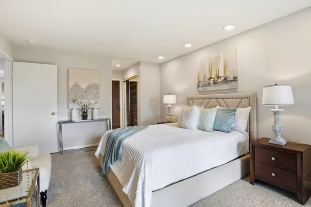 a en suite bathroom with a granite countertop sink and a mirror