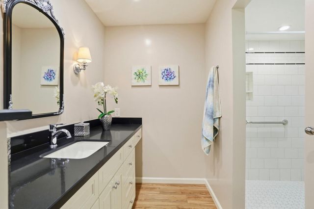 a bedroom with a bed and a large mirror