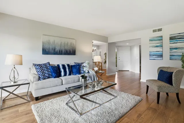 a kitchen with stainless steel appliances granite countertop a sink a stove a refrigerator and cabinets