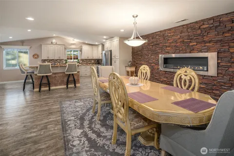 a dining room with furniture and wooden floor