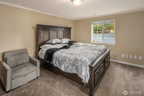 a bed sitting in a bedroom next to a window