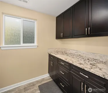 a view of a kitchen with wooden floor and staircase