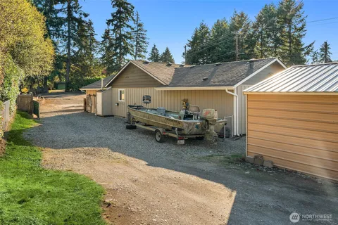 a white house that has sitting in the middle of a yard