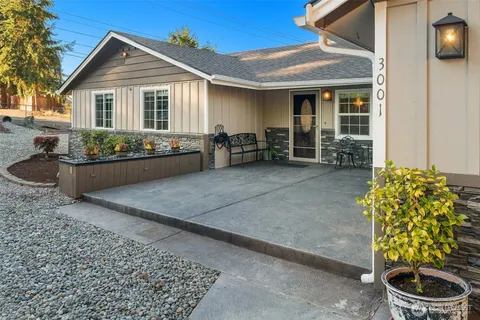 a view of a house with yard and sitting area