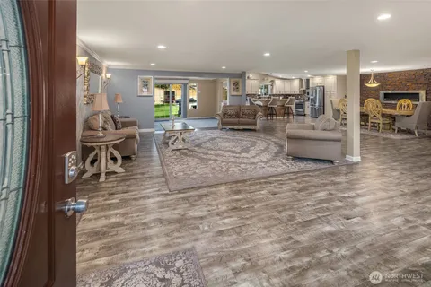 a living room with furniture and a dining table with kitchen view