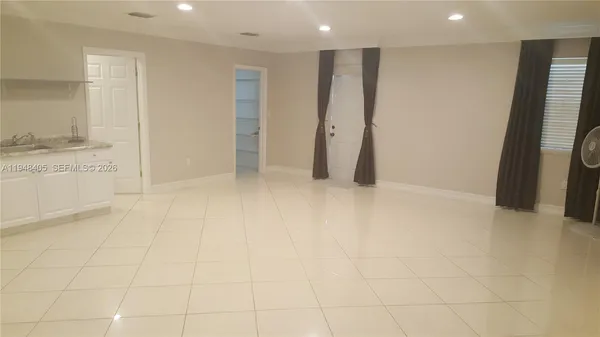 a bathroom with a shower sink and mirror