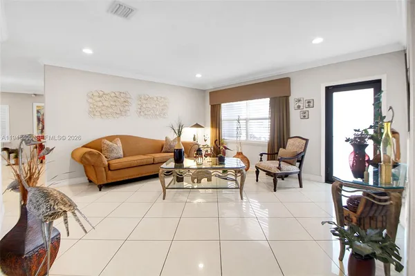 a living room with furniture a rug and a window