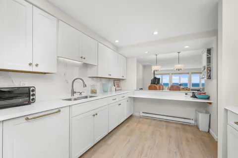 a kitchen with a sink cabinets and wooden floor