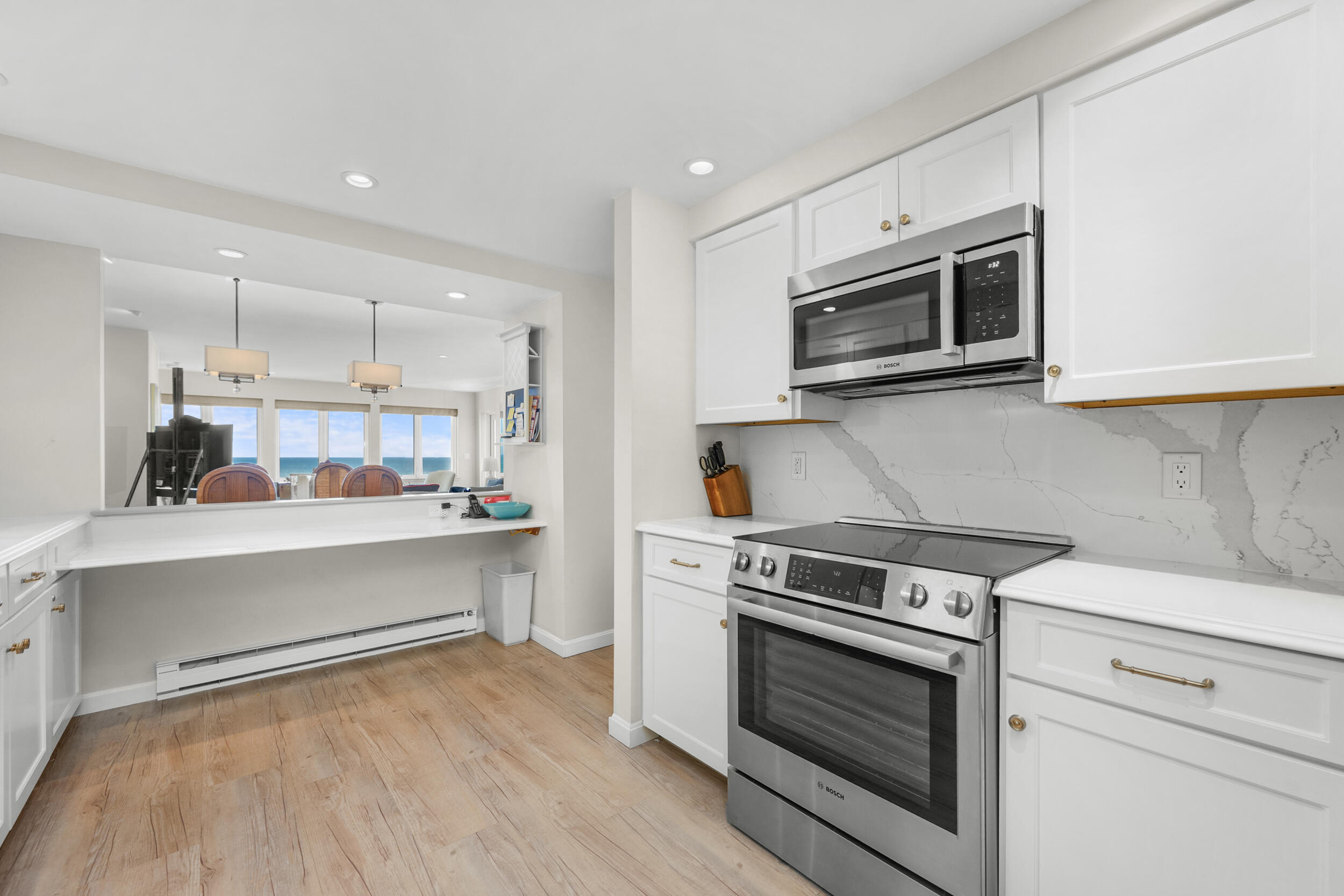 1 Belmont Road, Unit 341 West Harwich, MA 02671 - Photo 13 of 30 a kitchen with stainless steel appliances white cabinets and wooden floor
