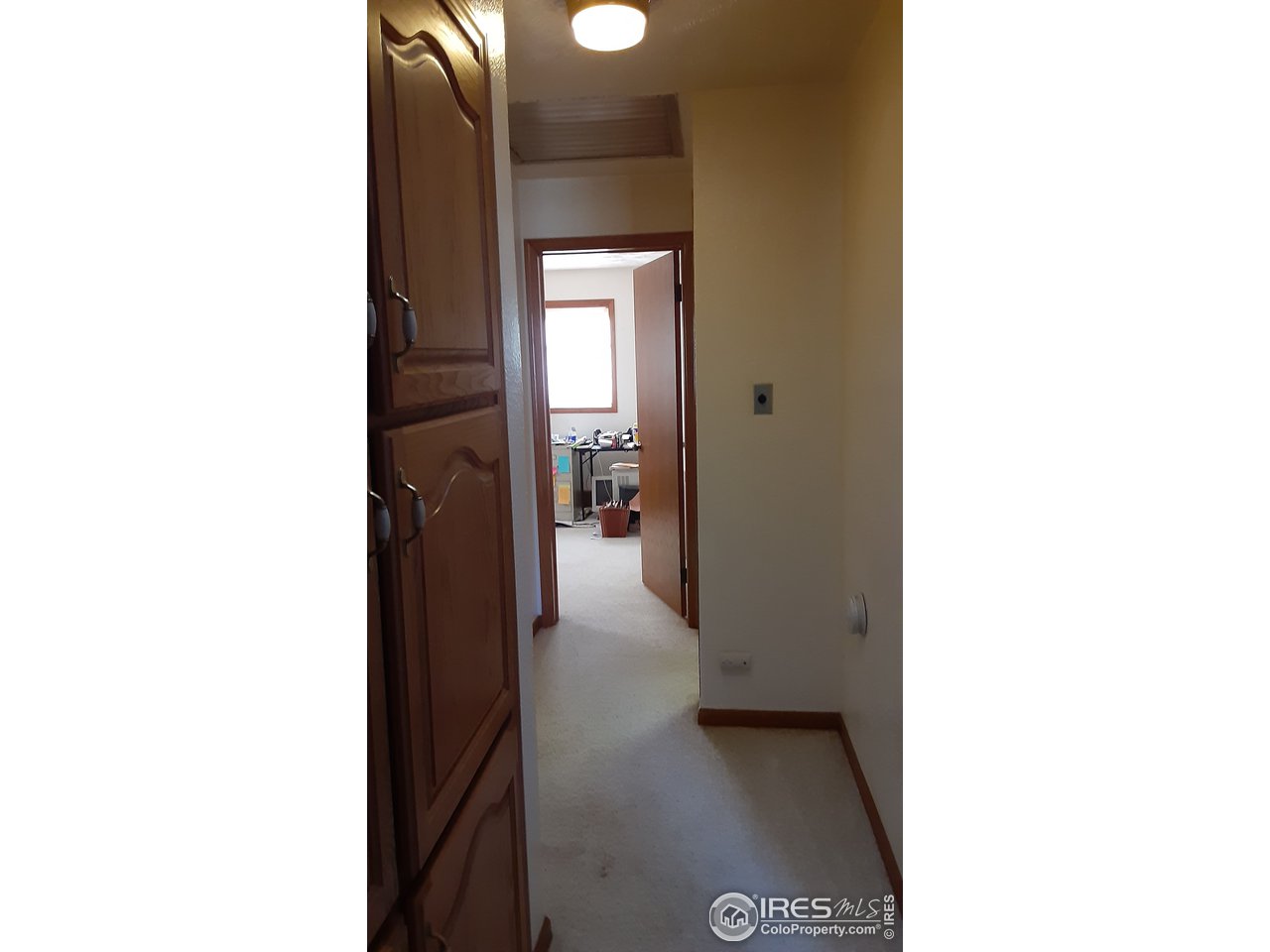1401 Adams Circle Sterling, CO 80751 - Photo 15 of 16 a view of a hallway with some white walls