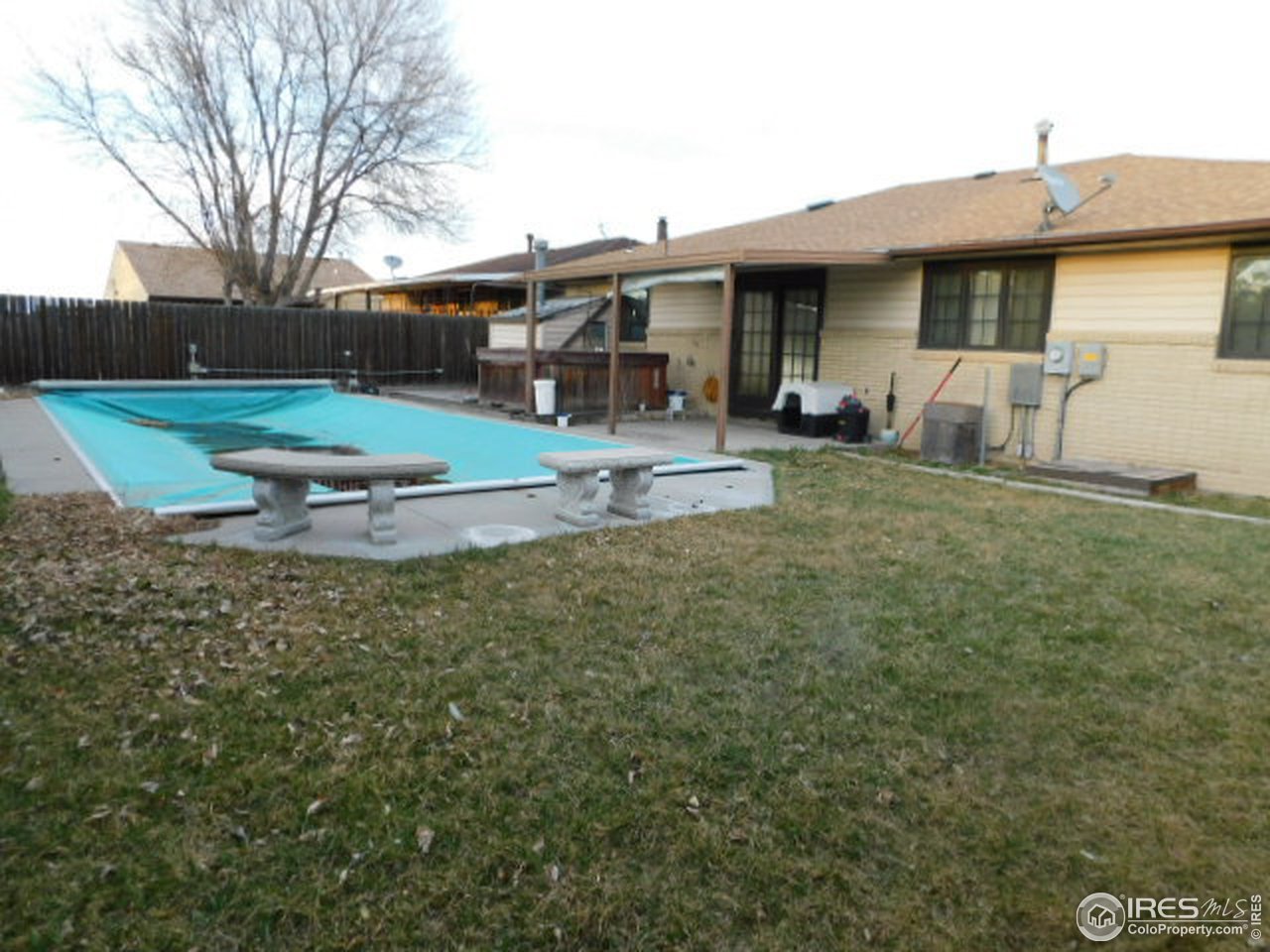 1401 Adams Circle Sterling, CO 80751 - Photo 16 of 16 a front view of a house with garden