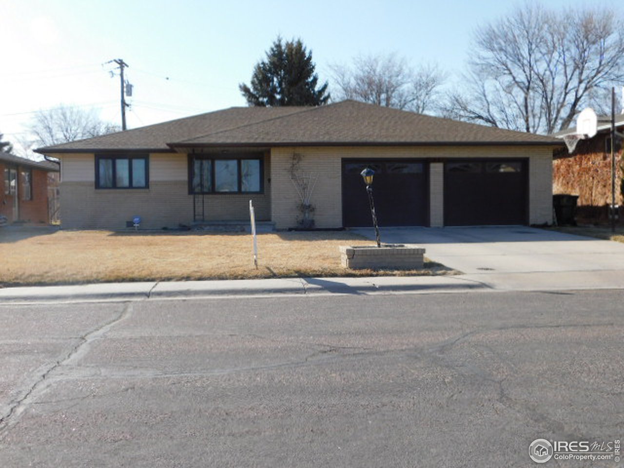 1401 Adams Circle Sterling, CO 80751 - Photo 2 of 16 a front view of a house with a parking space