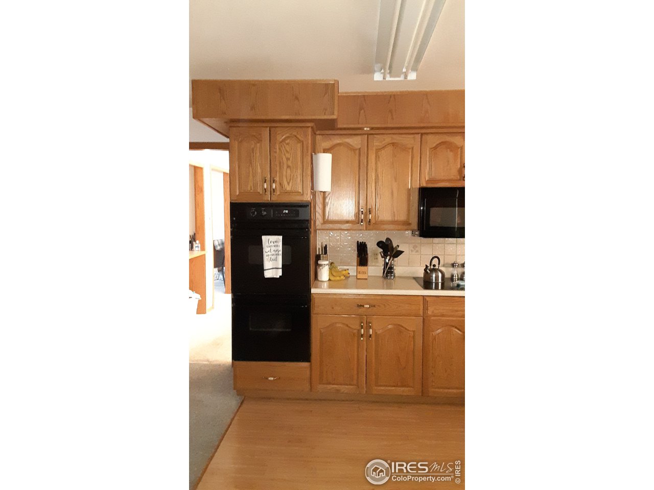 1401 Adams Circle Sterling, CO 80751 - Photo 5 of 16 a kitchen with a sink cabinets and a window