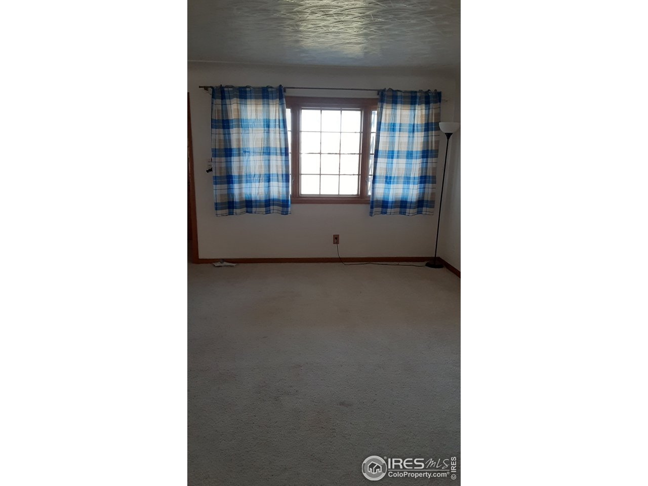 1401 Adams Circle Sterling, CO 80751 - Photo 6 of 16 a view of an empty room with a window