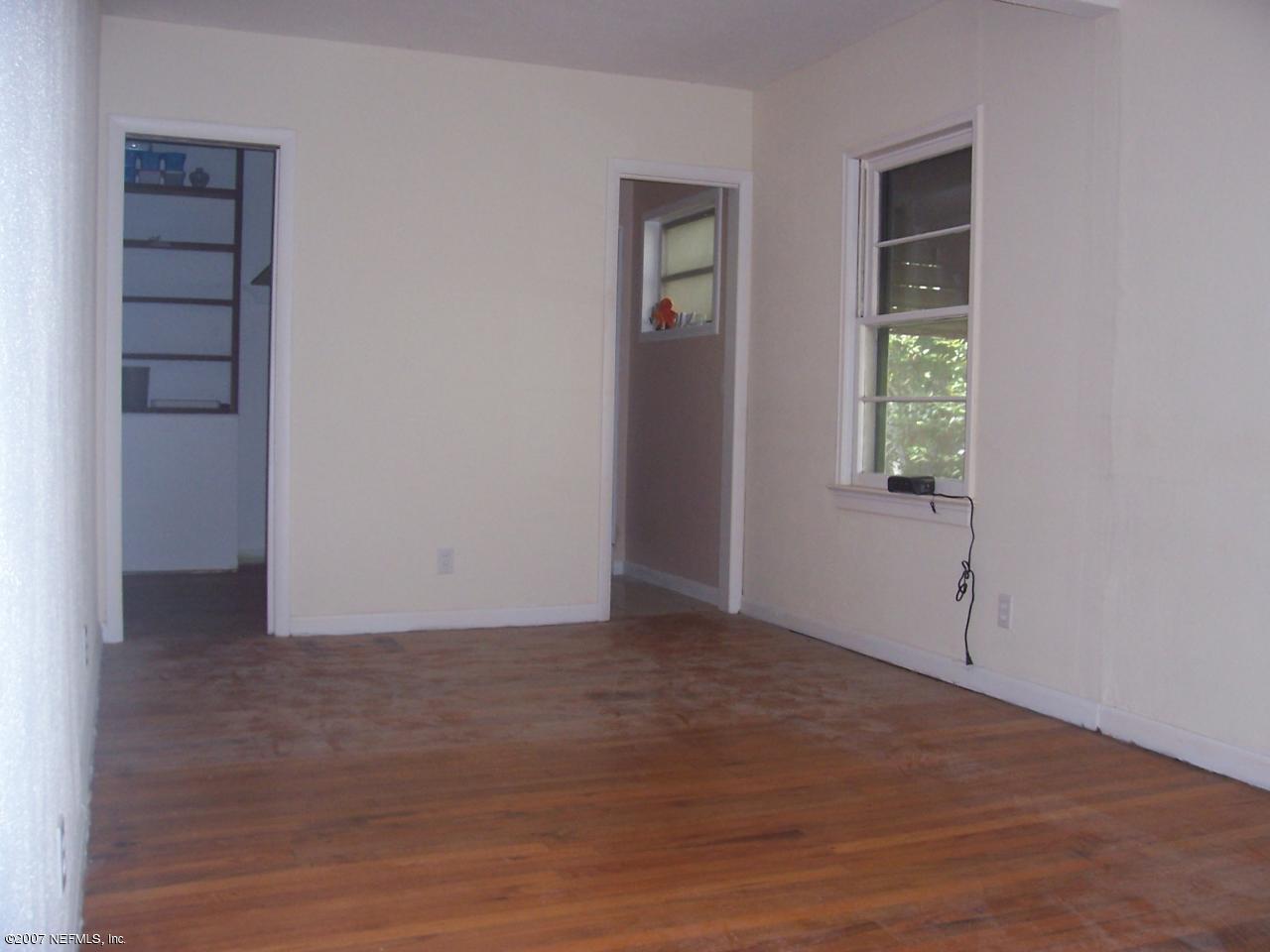 4908 Dundee Road Jacksonville, FL 32210 - Photo 11 of 16 an empty room with windows and closet