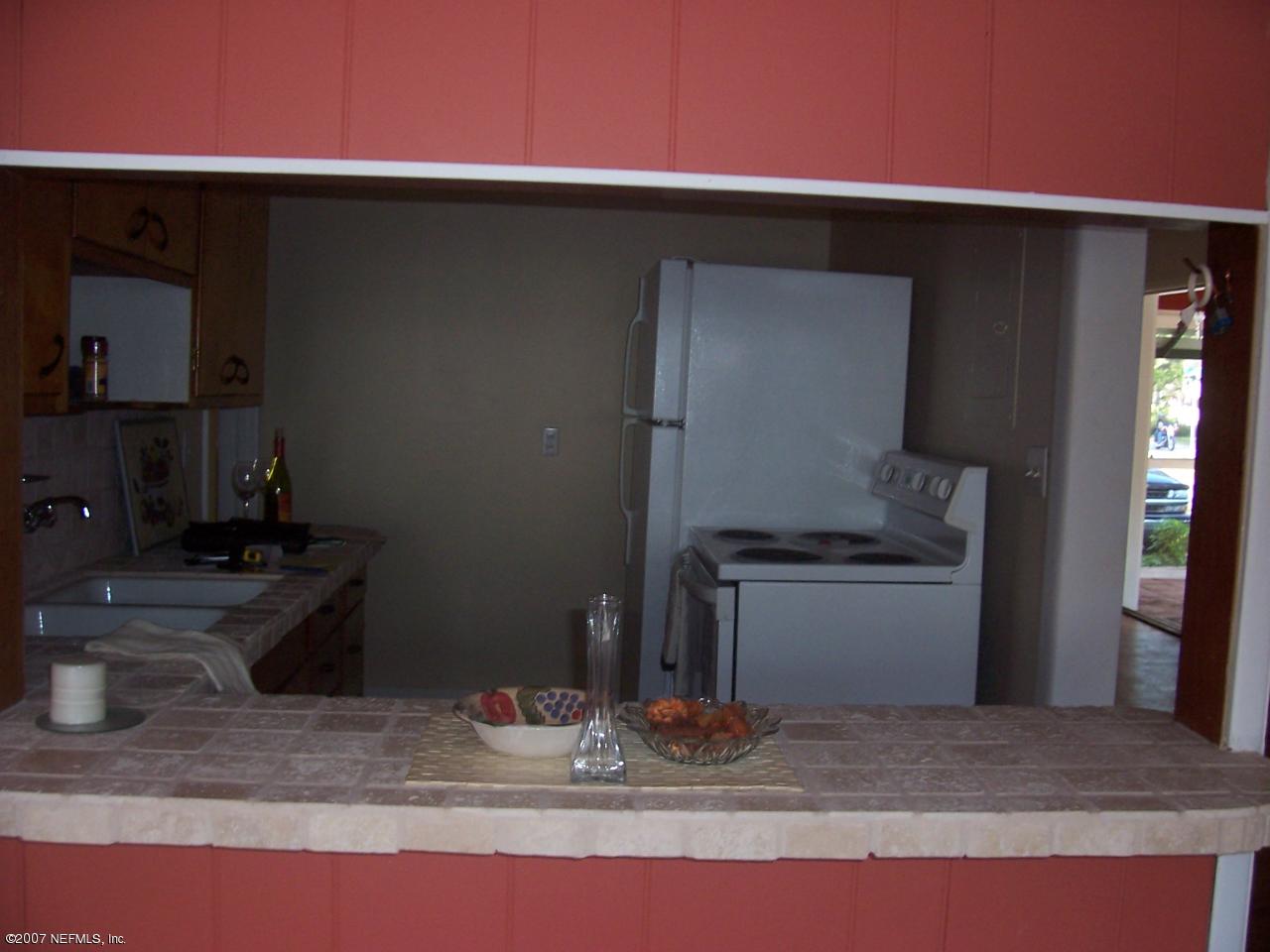 4908 Dundee Road Jacksonville, FL 32210 - Photo 3 of 16 a kitchen with a sink and a stove