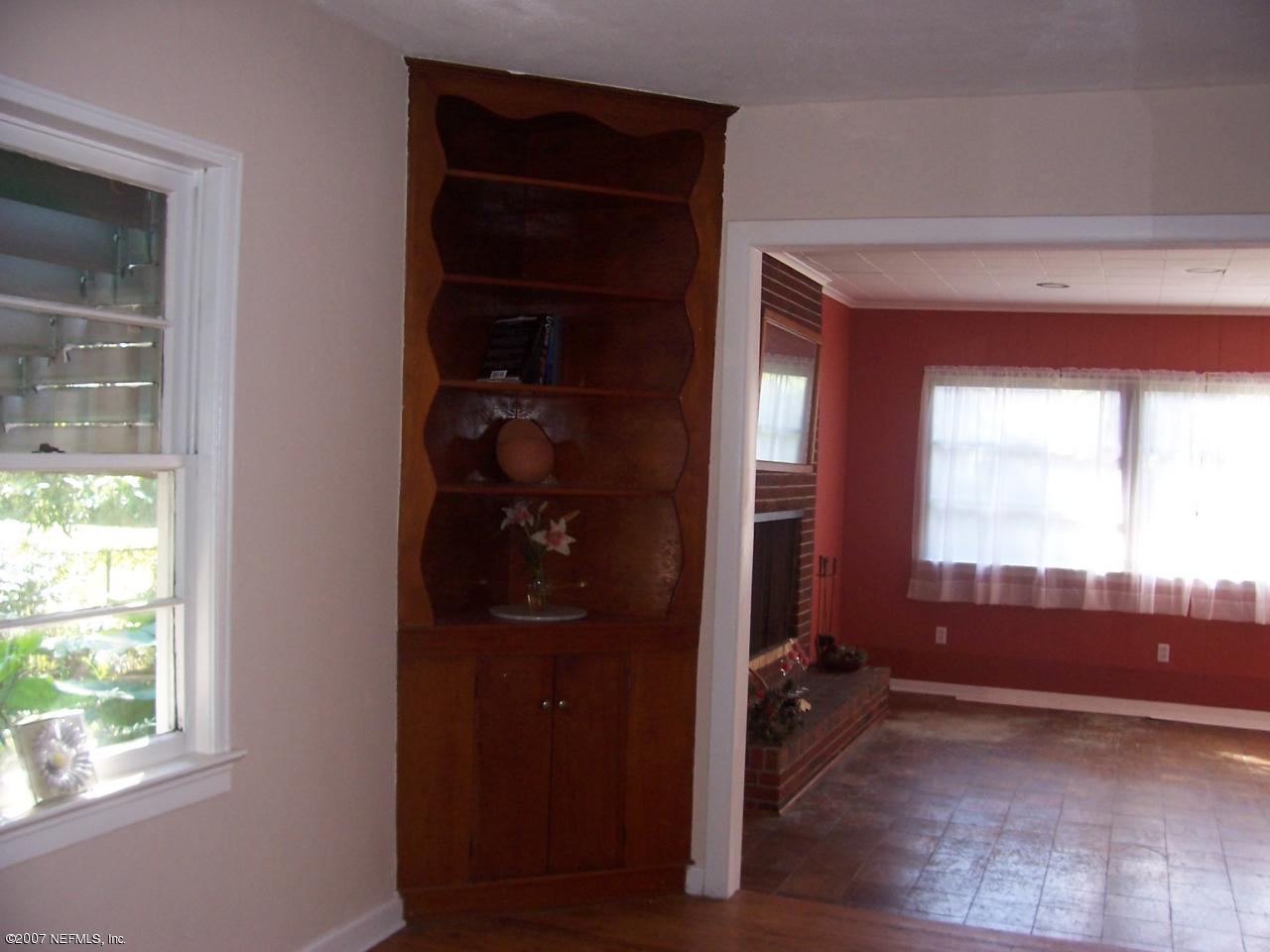 4908 Dundee Road Jacksonville, FL 32210 - Photo 6 of 16 an empty room with windows and closet