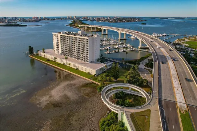 a living room with furniture a flat screen tv and kitchen view