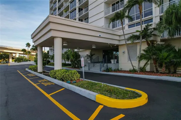 a kitchen with stainless steel appliances granite countertop a refrigerator a stove and a sink with wooden floor