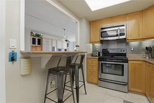 a spacious bedroom with a bed and a chandelier