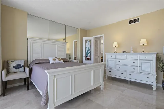 a bathroom with a granite countertop sink a toilet and a mirror