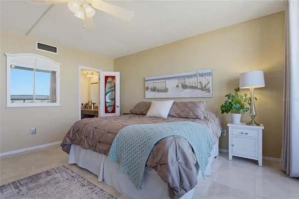 a view of water with boats and trees in the background