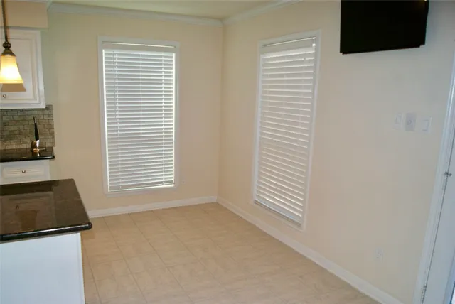 an empty room with a chandelier fan
