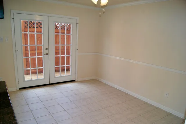 a view of an empty room with wooden floor and a fireplace