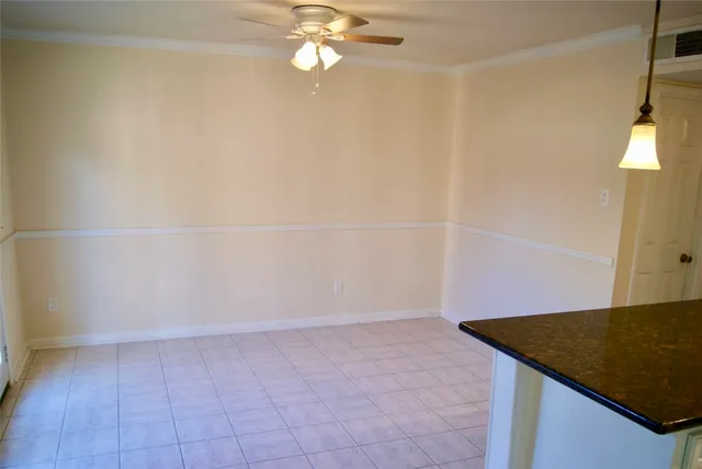 a view of an empty room with wooden floor and a fireplace