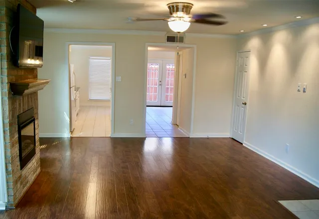 an empty room with a fan and a fan