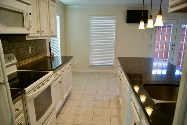 a view of a kitchen with an empty space and a window