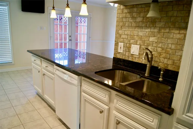 a view of a kitchen with an empty space and a window