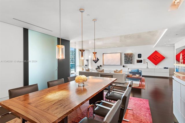 a bedroom with furniture and large windows