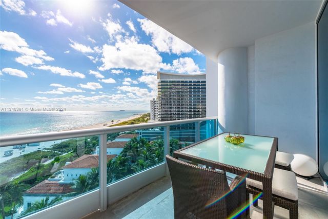 a bathroom with a shower and a chair