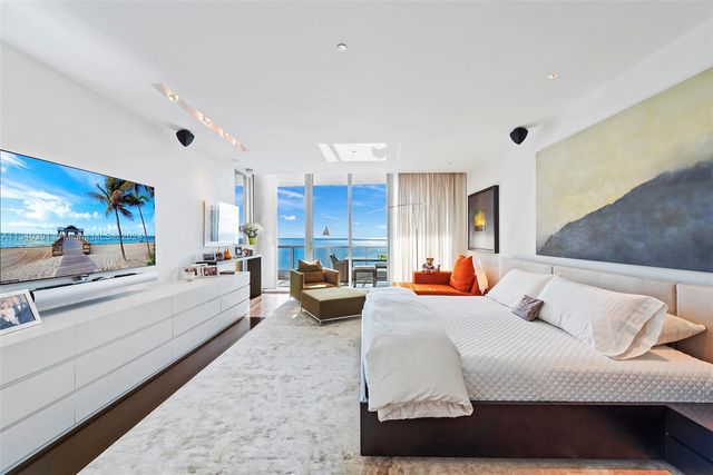 a living room with furniture gym equipment and a large window