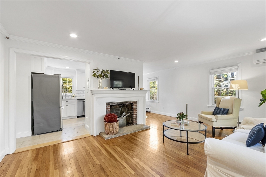 6 Gray Road Andover, MA 01810 - Photo 17 of 36 a living room with furniture a fireplace and a flat screen tv